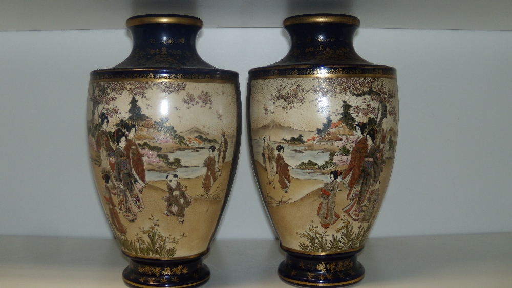 A pair of early 20th century Satsuma vases bearing Shimazu family mon and Satsuma marks, 26cm (10.25