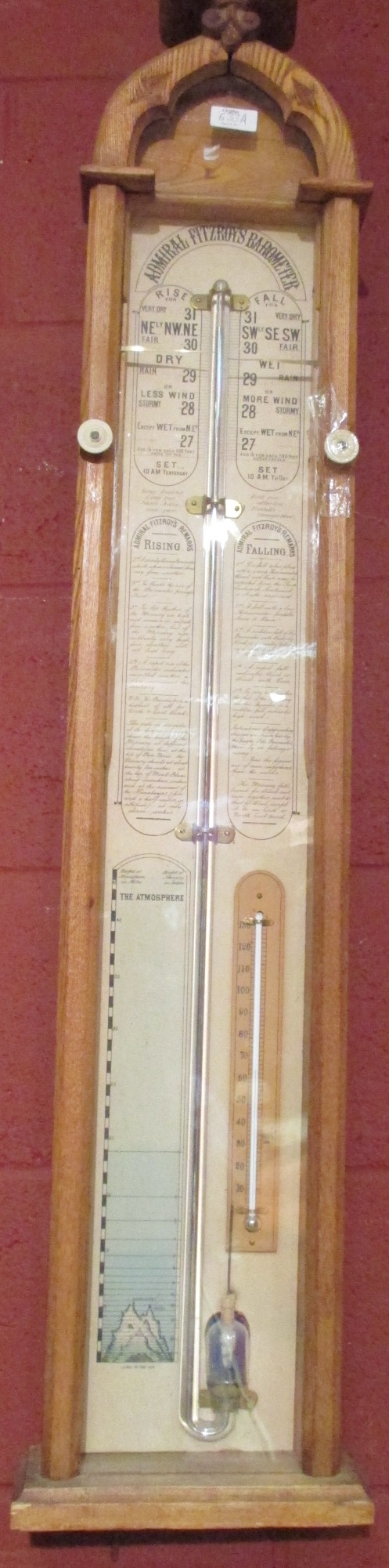 An oak Admiral Fitzroy barometer, late 19th century, the arched case with glazed front displaying