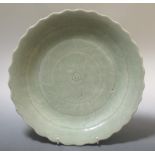 An 18th century celadon glazed dish, bearing the mark of Qianlong