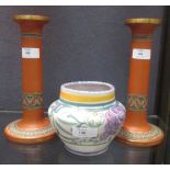 Atributed to Watcombe pottery; a pair of terracotta candlesticks and a Poole Carter Stabler Adams