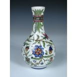 An early twentieth century Athens Pottery vase, the bottle form painted with an Iznik inspired