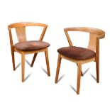 A set of four light oak 'Put-U-Up' dining chairs by Greaves & Thomas, each with a curved back and
