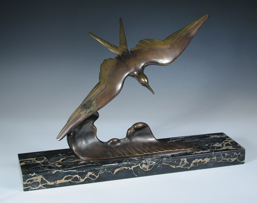 An Art Deco bronze model of a seagull, signed M. Seconde, modelled diving above a wave, mounted on a