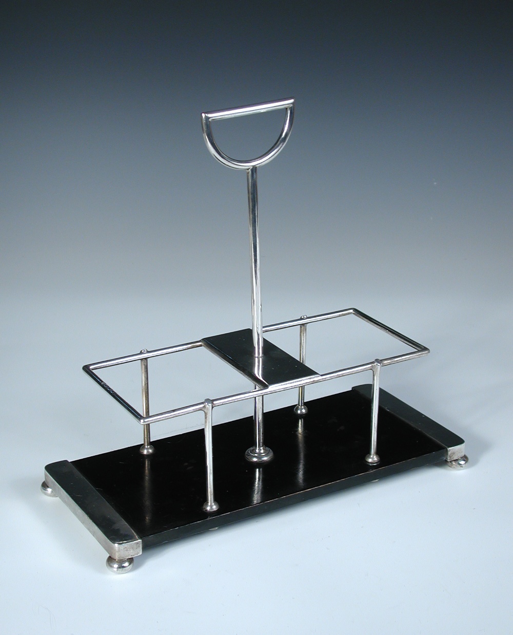 Dr. Christopher Dresser for Heath & Middleton, a silver mounted decanter stand, with 'D' shaped