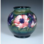 A Moorcroft anemone pattern vase, of globular form decorated to a green ground, painted and