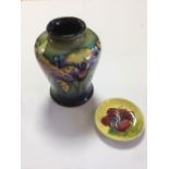 A Moorcroft orchid pattern vase, decorated to a green to blue ground, together with a Moorcroft