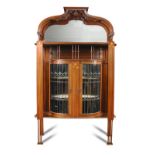 An Art Nouveau inlaid mahogany display cabinet, the shaped and pierced supastructure top with mirror