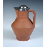 Dr. Christopher Dresser for Watcombe, Torquay, a terracotta jug, of angular form with silver cover
