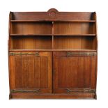 An Arts and Crafts oak bookcase in the manner of Bruce Talbert, the shelved upper section above