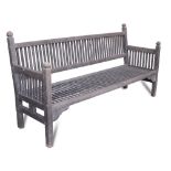 Attributed to Ambrose Heal for Heal & Son, a stained teak garden bench, the slated back, seat and