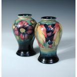 Two Moorcroft inverted baluster shape vases, the first in the leaves and berries pattern, the second