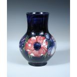 A Moorcroft Anemone pattern baluster vase, painted to a deep blue ground, painted and impressed