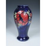 A Moorcroft Anemone pattern vase, the inverted baluster form decorated on a deep blue ground,