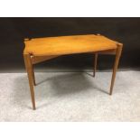 A mid 20th century Heal's teak occasional table, the shaped rectangular top supported on four