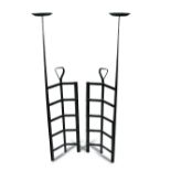 After Charles Rennie Mackintosh, a pair of wrought iron handirons, each of eight square sections