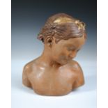 A mid 20th century Italian terracotta bust, indistinctly signed, modelled as young girl with a