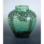 An earthenware vase by Professor Max Läuger, slip decorated with foliate design over pale green