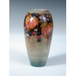 A Moorcroft leaves and berries pattern vase, of ovoid form with a flambé type glaze, painted and