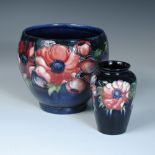 A Moorcroft Anemone pattern planter, decorated to a blue ground, together with a simliar small vase,