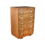 An Art Deco walnut chest of drawers, the rounded rectangular top above five long graduated drawers