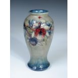 A Moorcroft Orchid pattern vase, the inverted baluster form decorated to a pale green to blue