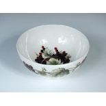 A Moorcroft grape vine pattern bowl, of circular footed form decorated on a white ground, painted