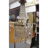 A brass framed chandelier with cut glass lustre drops