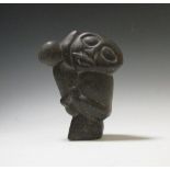 An Inuit carving of mother, child and seal, 21cm high, marked 'Fibron Peja' to base