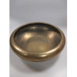 A Japanese polished bronze shallow bowl, signed Yoshimasa, 18cm diameter