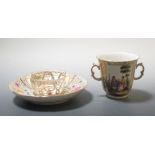A 19th Century Berlin porcelain trembleuse cup and saucer profusely decorated with gilded panels,
