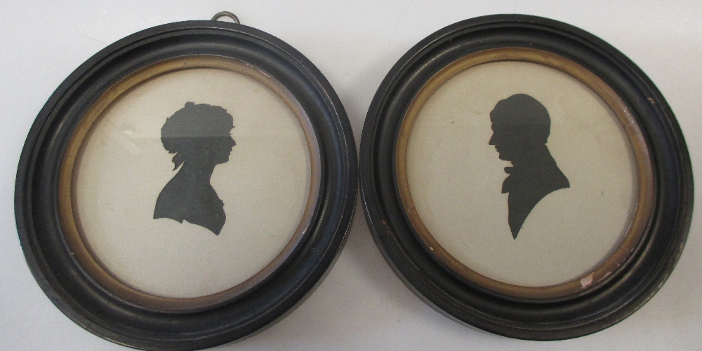 A pair of silhouettes of a Gentleman and Lady in profile, in circular frames; together with a pair - Image 2 of 4