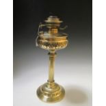 A late 19th/early 20th century brass oil lamp with later cream glass shade