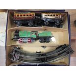 A boxed Hornby 'O 'Gauge clockwork train and track, including two Pullman coaches