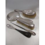 A silver five piece matched dressing table set