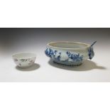 An 18th century Chinese blue and white tureen and a famille rose bowl