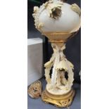 A Moore Bros oil lamp and a cherub decorated spill vase (2)