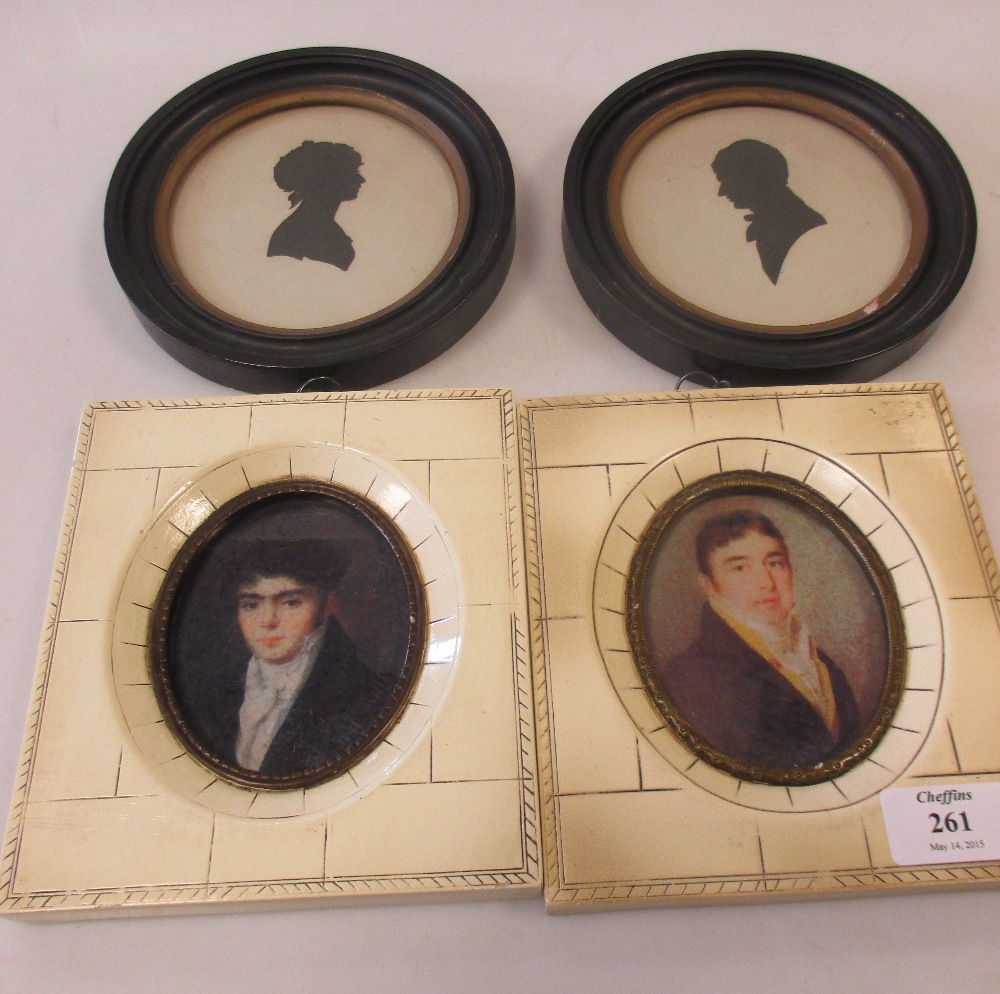 A pair of silhouettes of a Gentleman and Lady in profile, in circular frames; together with a pair