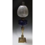 A brass oil lamp and shade
