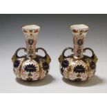 A pair of Crown Derby Imari palette two handled bottle vases