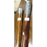 A white metal handled rosewood walking cane, and another (2)