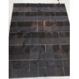 A brown patchwork pony skin rug, 225 x 173cm, and two cream patchwork pony skin cuhions (3)