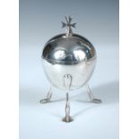 A Continental metalwares ciborium, the spherical body raised on three tall claw feet, the cover with