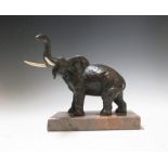 A bronze elephant standing four square on a marble base