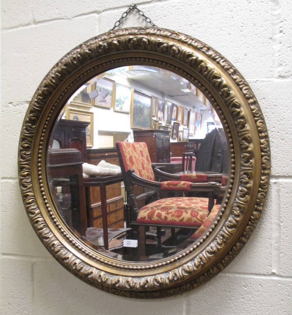 A circular gilt framed wall mirror, 69cm diameter