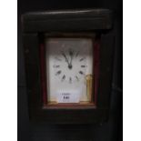 A brass carriage clock with repeat, unsigned, rectangular enamel dial, moon hands, 14cm high,