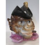 A German porcelain hatted monkey smoking compendium