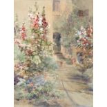 Edward Theodore Compton (British, 1849-1921) A house and garden in summer at Traunstein, Bavaria