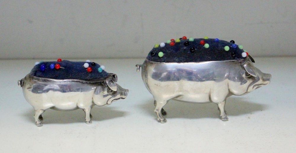 Two silver pincushions modelled as pigs, one by S&Co?, Birmingham 1904, 8.2cm long; the other by