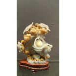 A Chinese agate group of birds and bats by a pine tree, 16.5cm high There are some minor breaks to