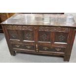 An 18th century carved oak mule chest on stile legs